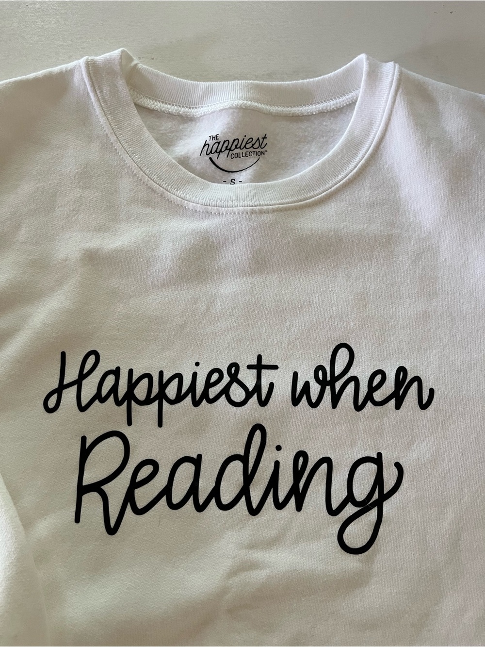 Soft and cozy white “Happiest When Reading” sweatshirt. Size S.